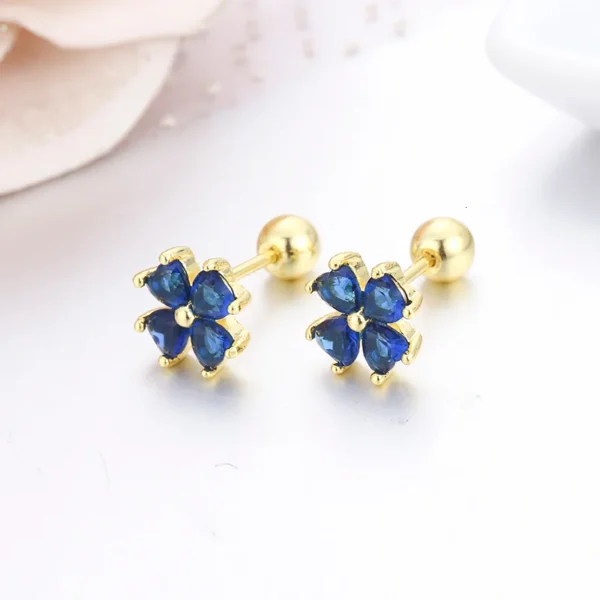 Boucles d&rsquo;oreilles trèfle dorées cristaux bleus